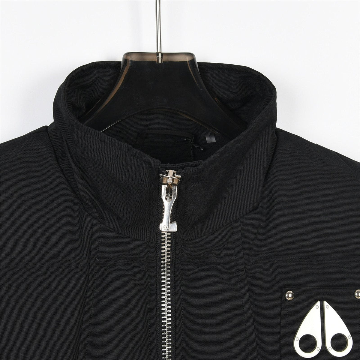 Moose Knuckles Down Vest — Metal Handcuff Badge, Silver Studs, Dual Pockets (Black / White)